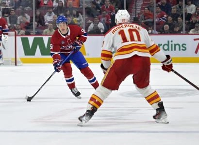 Nov 5, 2024; Montreal, Quebec, CAN; Montreal Canadiens forward Oliver Kapanen (91) plays the puck and Calgary Flames forward Jonathan Huberdeau (10) defends during the second period at the Bell Centre. Mandatory Credit: Eric Bolte-Imagn Images Nov 5, 2024; Montreal, Quebec, CAN; Montreal Canadiens forward Oliver Kapanen (91) plays the puck and Calgary Flames forward Jonathan Huberdeau (10) defends during the second period at the Bell Centre. Mandatory Credit: Eric Bolte-Imagn Images