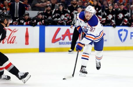 Mar 10, 2025; Buffalo, New York, USA; Edmonton Oilers center Connor McDavid (97) takes a shot during the third period against the Buffalo Sabres at KeyBank Center. Mandatory Credit: Timothy T. Ludwig-Imagn Images