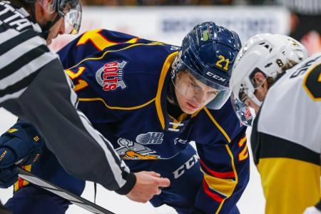Riley Patterson taking a face-off for the OHL's Barrie Colts.