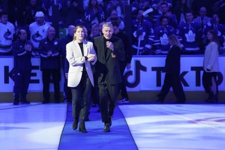 Toronto Maple Leafs alumni and Hall of Famer Borje Salming and his wife Pia walk to center ice for a ceremony before a game between the Vancouver Canucks and Toronto Maple Leafs at Scotiabank Arena.