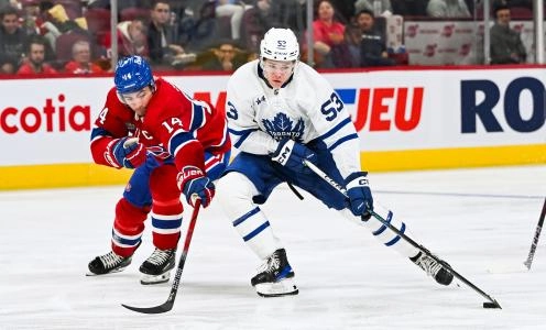 Sep 30, 2023; Montreal, Quebec, CAN; Toronto Maple Leafs right wing Easton Cowan (53) plays the puck against Montreal Canadiens center Nick Suzuki (14) during the third period at Bell Centre