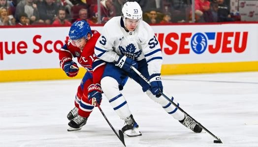 Sep 30, 2023; Montreal, Quebec, CAN; Toronto Maple Leafs right wing Easton Cowan (53) plays the puck against Montreal Canadiens center Nick Suzuki (14) during the third period at Bell Centre