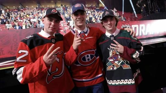 Photo of Juraj Slafkovsky and Logan Cooley Photo of Juraj Slafkovsky and Logan Cooley