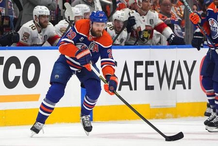 Leon Draisaitl carries puck up ice during a home game