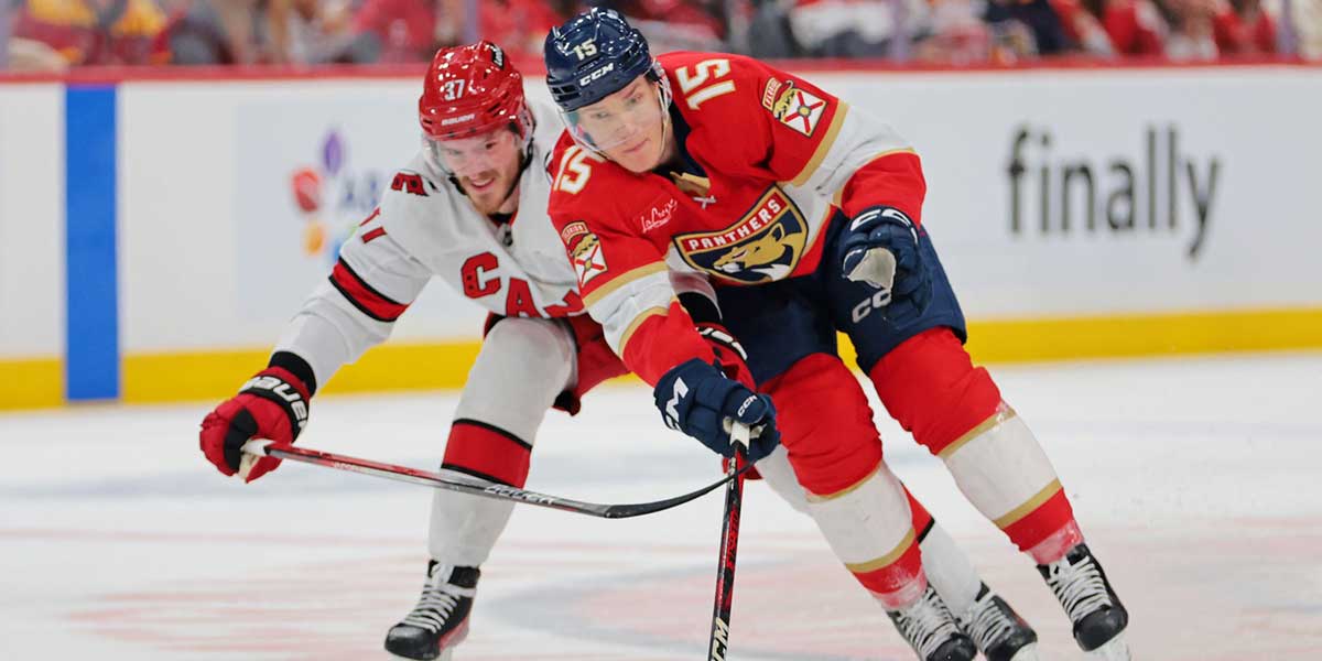Florida Panthers center Anton Lundell (15) and Carolina Hurricanes right wing Andrei Svechnikov (37) battle for the puck during the second period in game four of the Eastern Conference Final of the 2025 Stanley Cup Playoffs at Amerant Bank Arena.