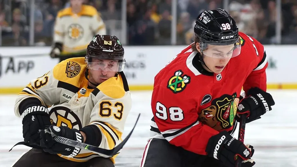 Connor Bedard #98 of the Chicago Blackhawks skates against Brad Marchand #63 of the Boston Bruins during the third period of the Bruins home opener at TD Garden on October 11, 2023 in Boston, Massachusetts.