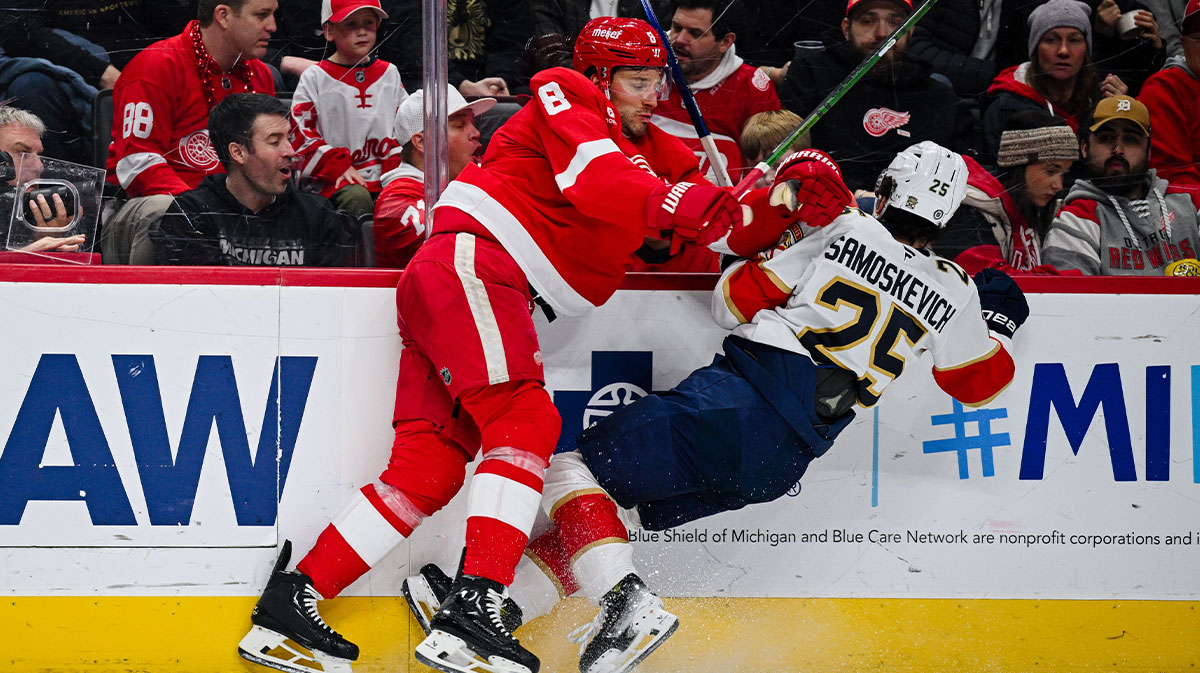 Detroit Red Wings defenseman Ben Chiarot (8) checks Florida Panthers right wing Mackie Samoskevich (25) during the third period at Little Caesars Arena.