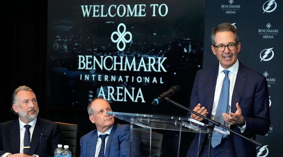 Tampa Bay Lightning co-owner Doug Ostrover, right, speaks as Benchmark International chariman and co-founder Steven Keane, left, and Vinik Sports Group CEO Steve Griggs, center, look on after Vinik Sports Group and Benchmark International announce a multi-year naming rights partnership for the arena during a news conference Wednesday, Aug. 13, 2025, in Tampa, Fla. (AP Photo/Chris O'Meara)