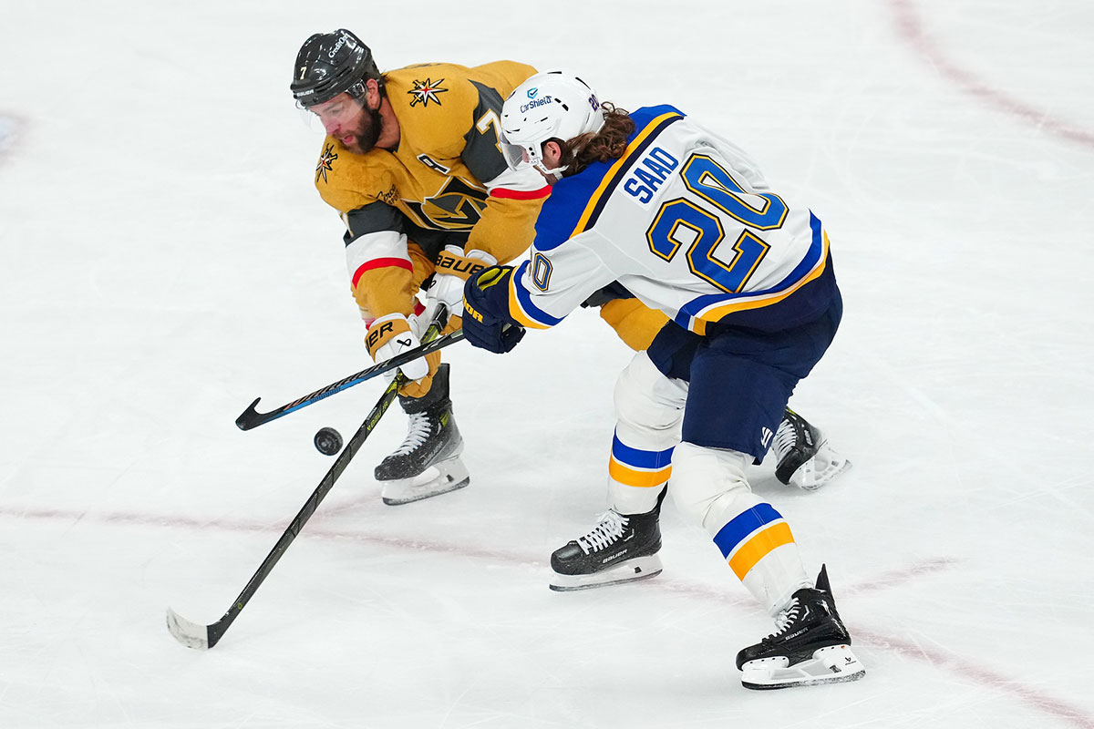 Vegas Golden Knights defenseman Alex Pietrangelo (7) deflects a shot attempt by St. Louis Blues left wing Brandon Saad (20) during the third period at T-Mobile Arena.