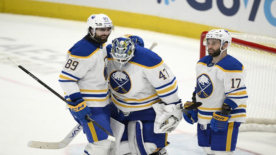 Buffalo right wing Alex Tuch celebrates with goaltender James Reimer after a game against the Washington Capitals.