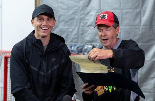 Former Blackhawks right wing Patrick Kane smiles while Alderman Brian Hopkins of the 2nd Ward reads out a formal proclamation declaring Friday, Aug. 8, 2025 to be Patrick Kane Day at Johnny's Ice House West in the United Center neighborhood of Chicago. (Dominic Di Palermo/Chicago Tribune)