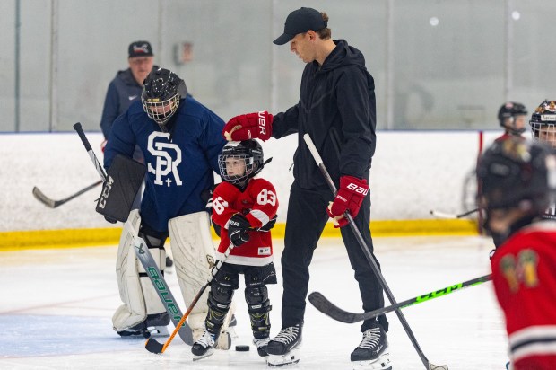 Former Blackhawks right wing Patrick Kane, right, skates around with his son Patrick Kane III, middle, and youth hockey players during Patrick Kane Day Friday, Aug. 8, 2025 at Johnny's Ice House West in the United Center neighborhood of Chicago. The City of Chicago officially named Aug. 8 Patrick Kane Day. Kane donated multiple items to the youth that attended the skate around including hockey sticks, helmets, gloves and more.(Dominic Di Palermo/Chicago Tribune)