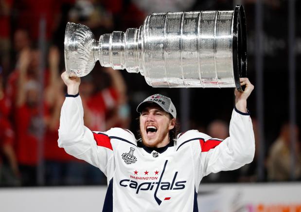 FILE - Washington Capitals right wing T.J. Oshie hoists the Stanley Cup after the Capitals defeated the Golden Knights 4-3 in Game 5 of the NHL hockey Stanley Cup Finals Thursday, June 7, 2018, in Las Vegas. (AP Photo/John Locher, File)