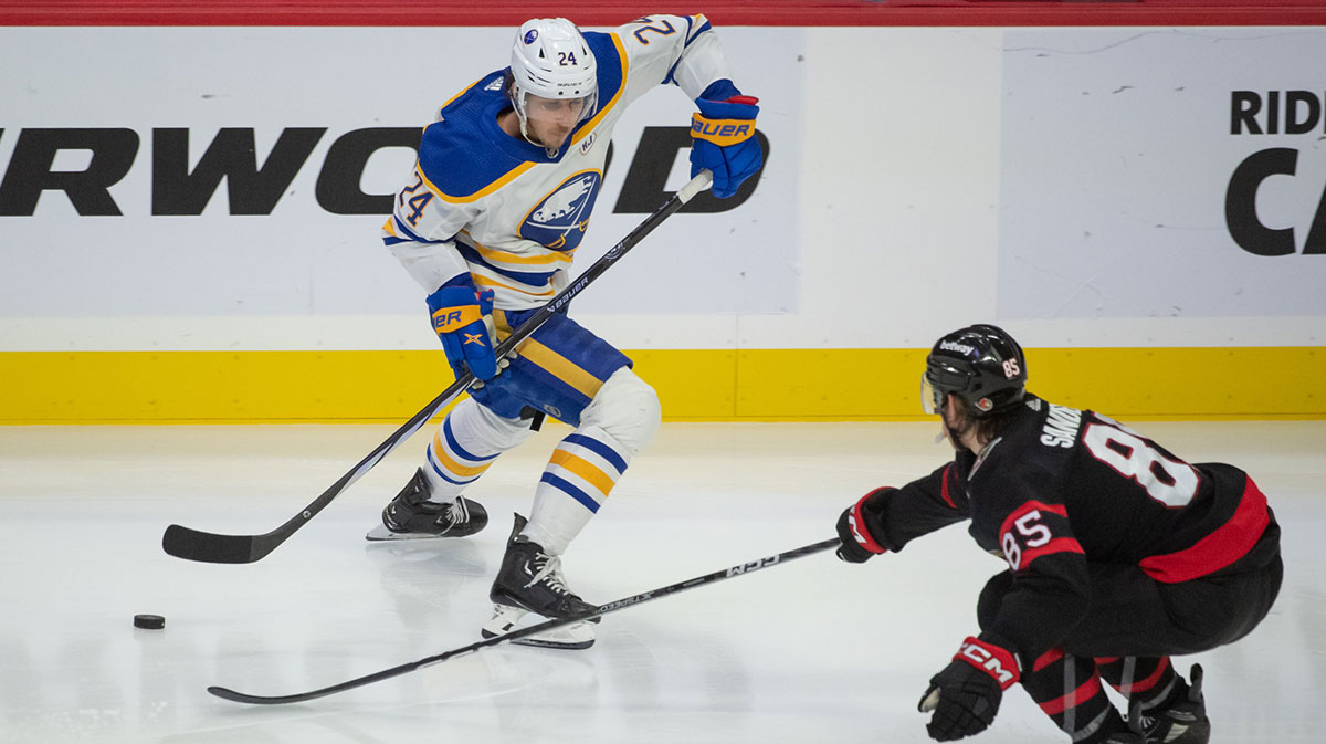 Buffalo Sabres center Dylan Cozens (24) moves the puck past Ottawa Senators defenseman Jake Sanderson (85) in the third period at the Canadian Tire Centre.