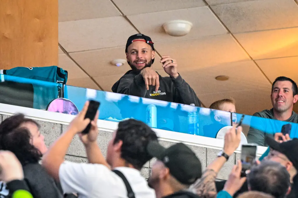 Golden State Warriors star Stephen Curry attending a San Jose Sharks game.