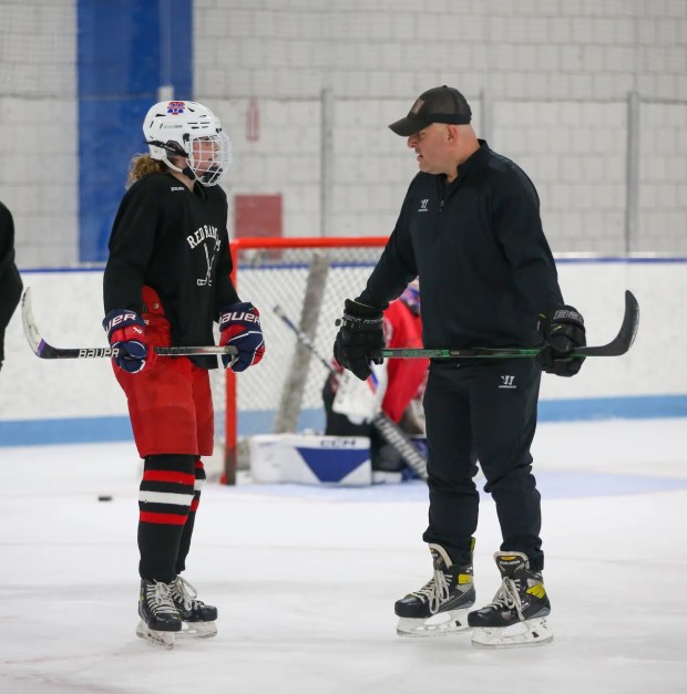Methuen/Tewksbury player Sarah Doherty, left, speaks with coach Dave O'Hearn during practice on Jan. 26, 2023 in Haverhill. (Photo by Reba Saldanha/Boston Herald)