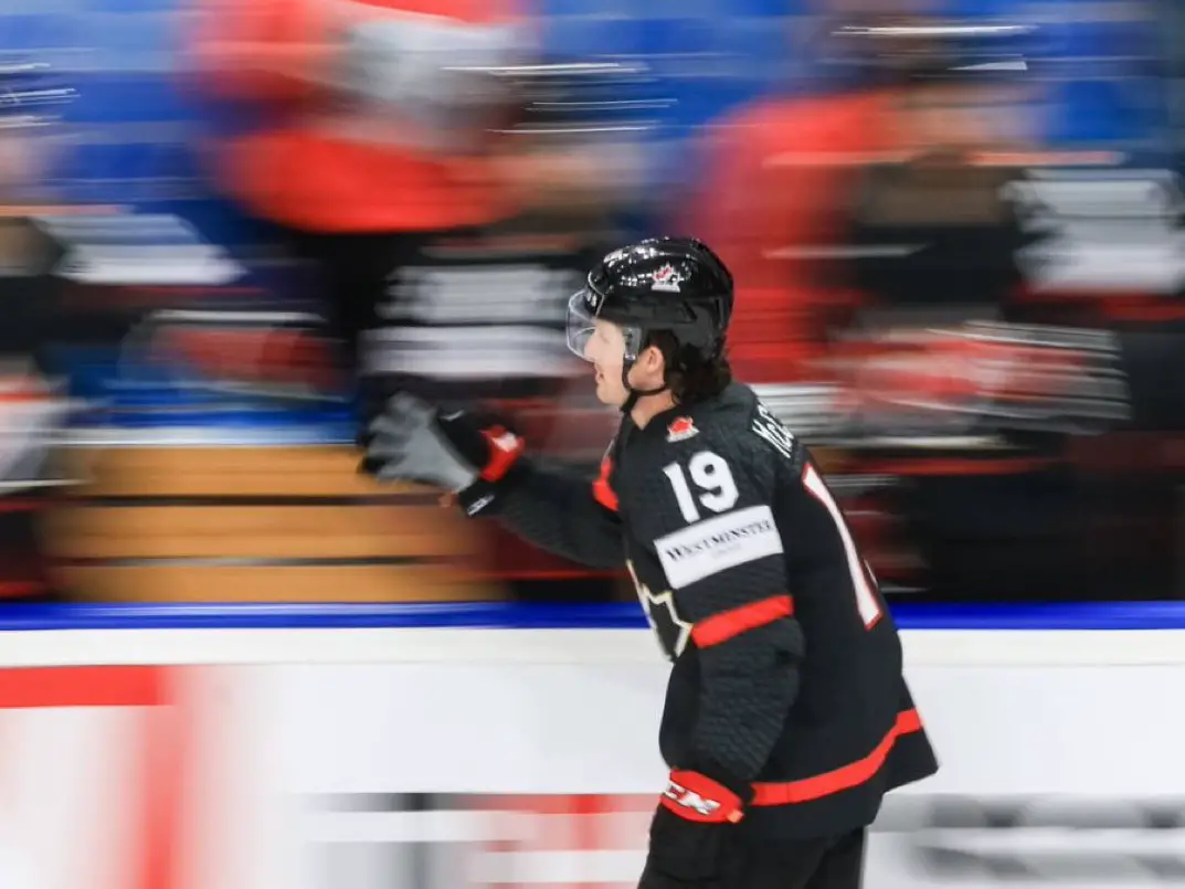 Jared McCann skating past the Team Canada bench