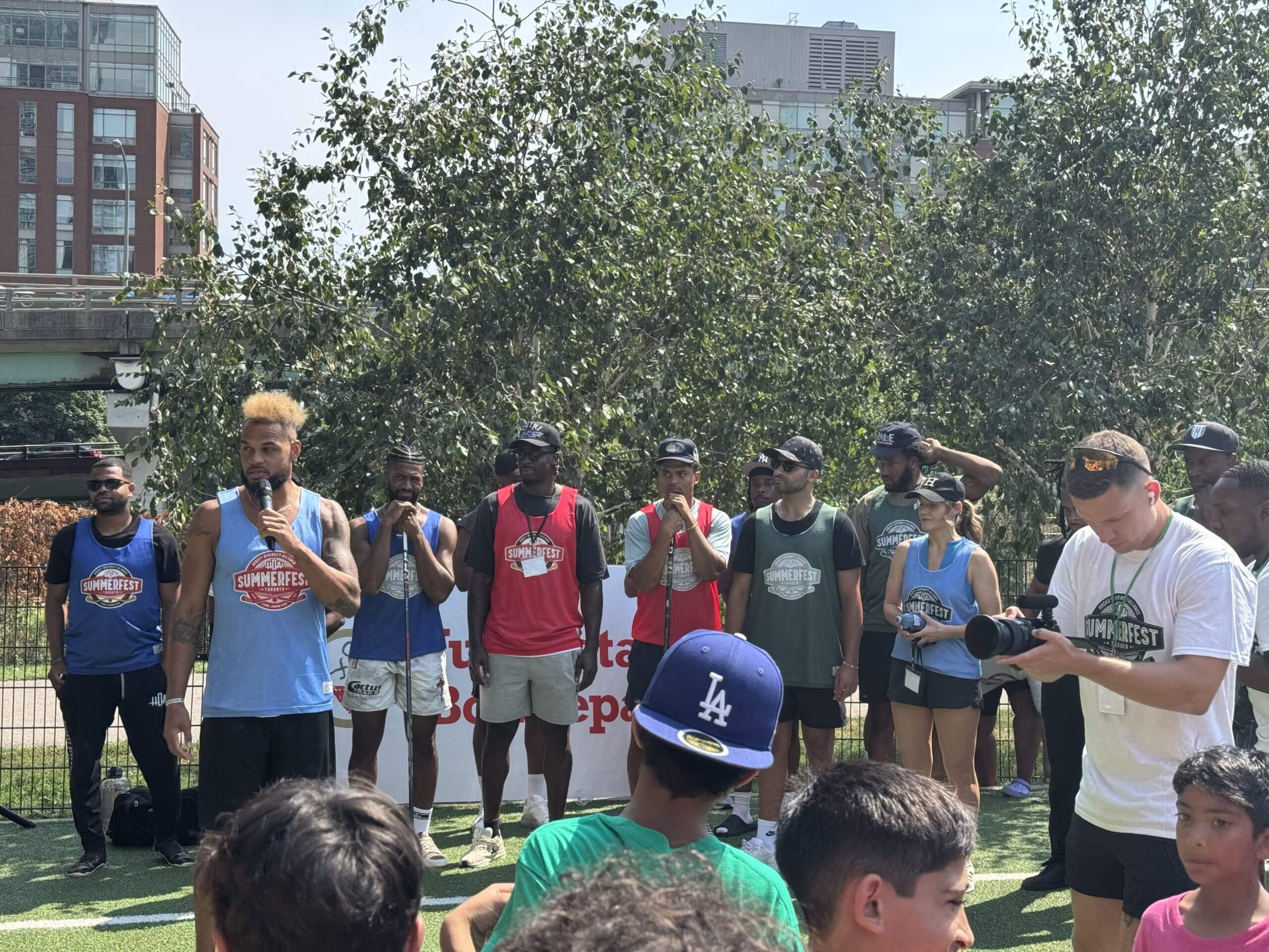 HDA chair and co-founder Akim Aliu speaks to the crowd at the 2025 HDA Summerfest event in downtown Toronto