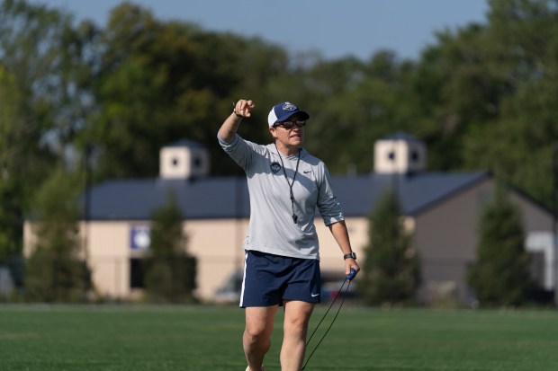 Moe Butler directs the UConn hockey team in an outdoor workout this summer. (UConn Athletics)