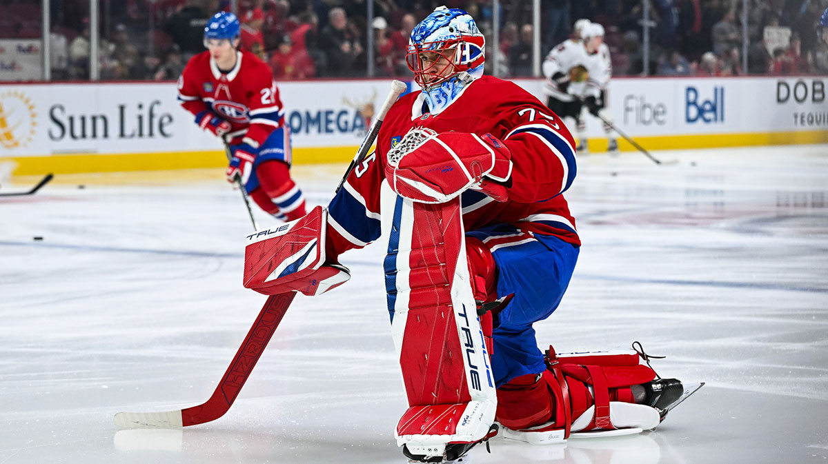 Montreal Canadiens goalie Jakub Dobes (75) kneels on the ice in warm-up before the game against the Chicago Blackhawks at Bell Centre.