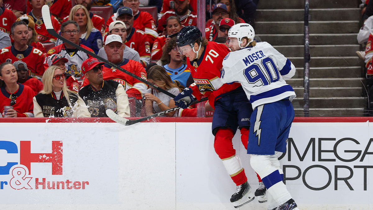 Tampa Bay Lightning defenseman J.J. Moser (90) pushes Florida Panthers center Jesper Boqvist (70) into the boards in the first period during game three of the first round of the 2025 Stanley Cup Playoffs at Amerant Bank Arena. 
