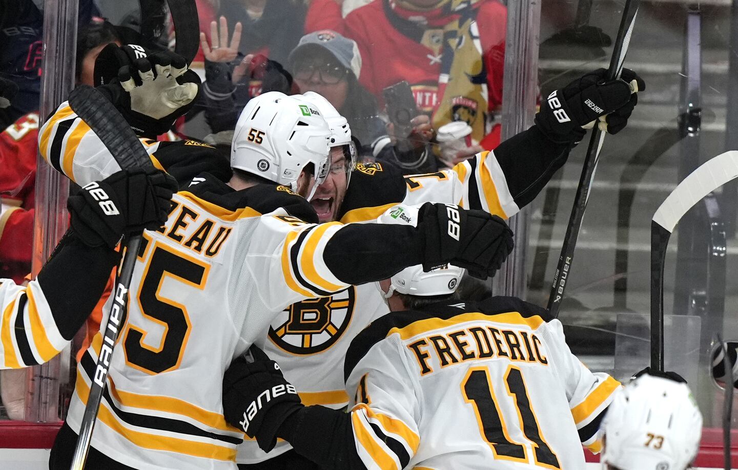 Oliver Wahlstrom (center) celebrates his first Bruins goal with linemates Justin Brazeau and Trent Frederic during the third period.