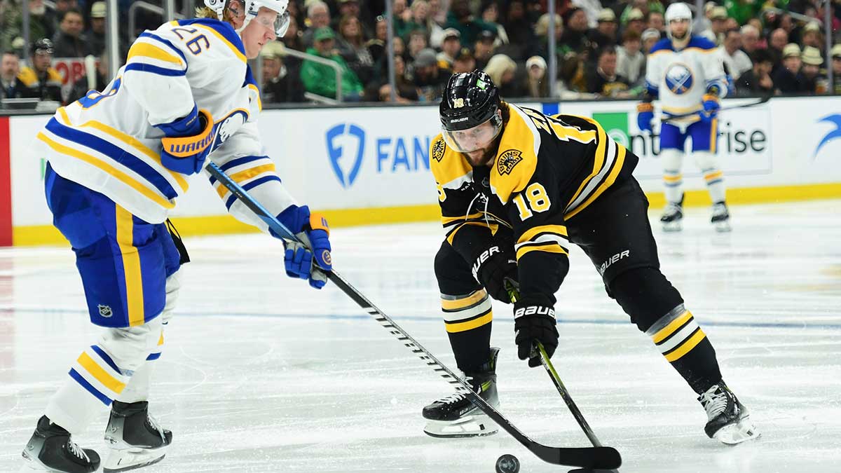Buffalo Sabres defenseman Rasmus Dahlin (26) and Boston Bruins center Pavel Zacha (18) battle for the puck during the third period at TD Garden. 