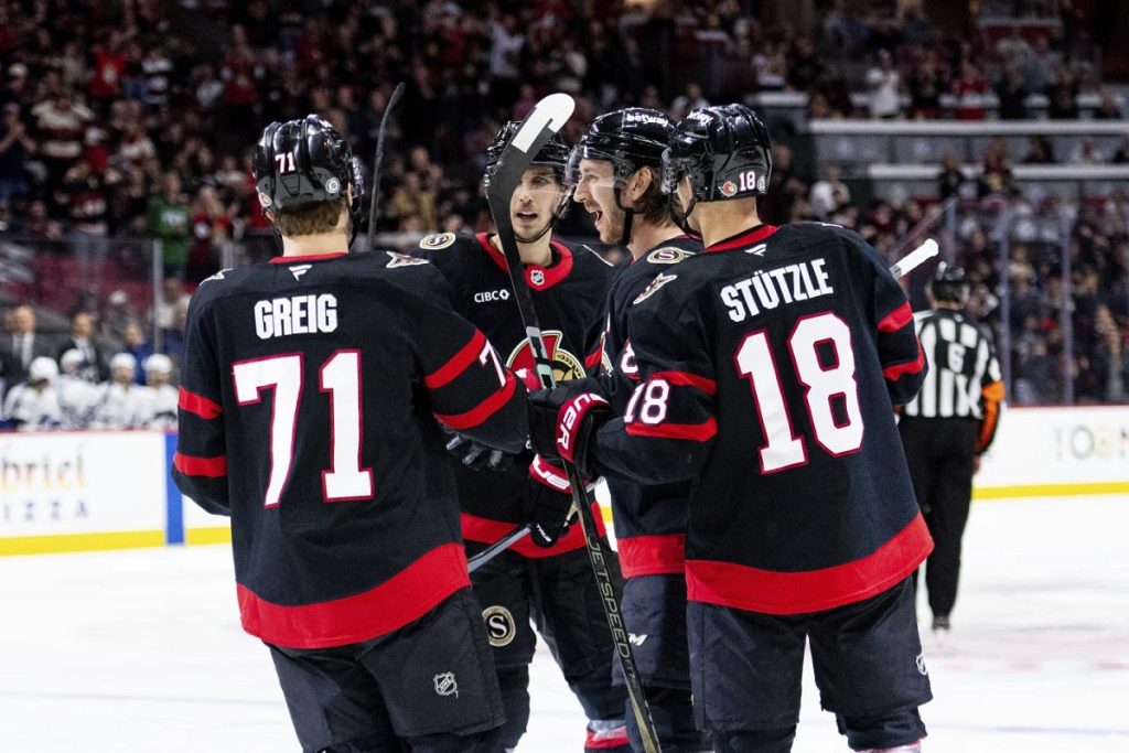 Ottawa Senators defenceman Jake Sanderson, centre-right, celebrates his goal with teammates during second period NHL hockey action against the Tampa Bay Lightning in Ottawa, on Thursday, April 3, 2025. (Spencer Colby/The Canadian Press via AP)