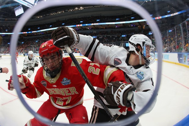 James Reeder (27) of the University of Denver Pioneers fights off Brian Kramer (14) of the Western Michigan University Broncos in the fist period of the Frozen Four semifinals at Enterprise Center on April 10, 2025, in St Louis. (Photo by Dilip Vishwanat/Getty Images)