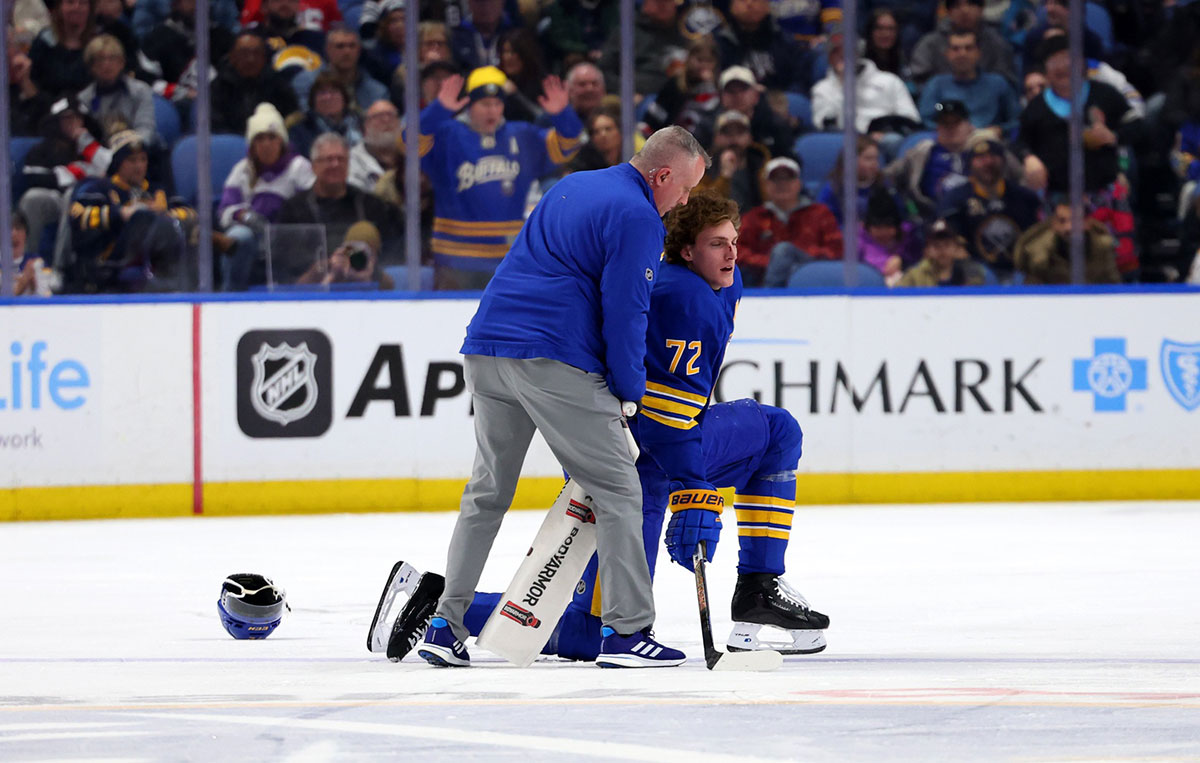 A trainer attends to Buffalo Sabres center Tage Thompson (72) after getting hurt during the third period against the New Jersey Devils at KeyBank Center.