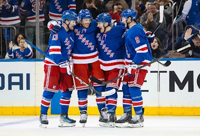 New York Rangers forward J.T. Miller celebrates goal with teammates during 2025 game.