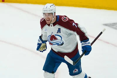 Colorado Avalanche defenseman Devon Toews reacts after scoring goal in 2025 game.