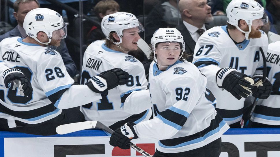 Utah Hockey Club's Logan Cooley (92) celebrates after his goal against the Vancouver Canucks with teammates during the third period of an NHL hockey game in Vancouver, British Columbia, Sunday, March 16, 2025. (Ethan Cairns/The Canadian Press via AP)