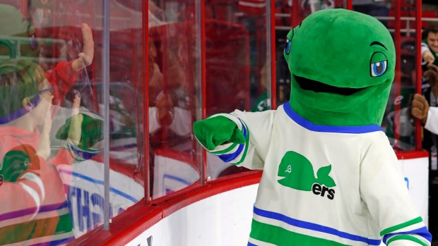 "Pucky The Whale", the mascot of the Hartford Whalers interacts with kids following an NHL hockey game between the Boston Bruins and the Carolina Hurricanes, Sunday, Dec. 23, 2018, in Raleigh, N.C. (AP Photo/Karl B DeBlaker)