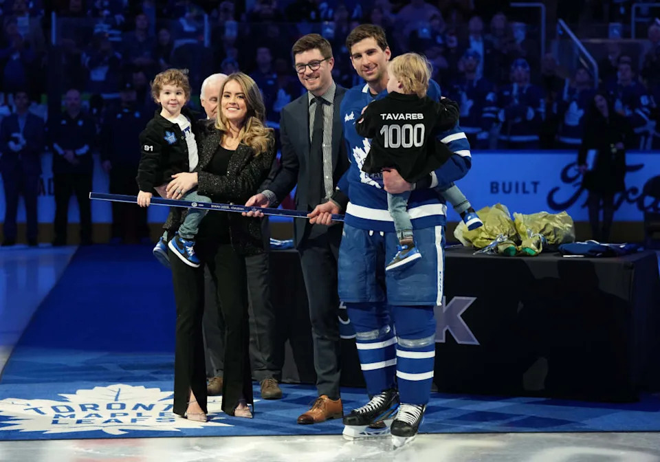 Toronto Maple Leafs center John Tavares (91) receives a commemorative hockey stick from GM Kyle Dubas.Nick Turchiaro-USA TODAY Sports via Imagn Images