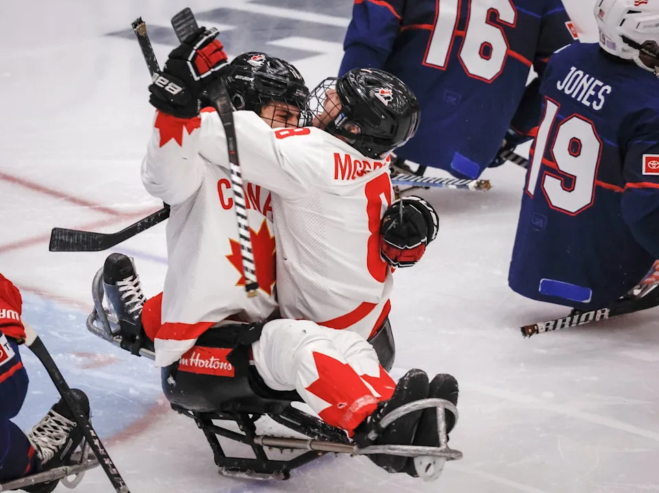 Team Canada forward Dominic Cozzolino (19) celebrates his goal with teammate forward Tyler McGregor (8) during first period action against Team USA in the World Para Ice Hockey Championship final in Calgary, Sunday, May 12, 2024.THE CANADIAN PRESS/Jeff McIntosh