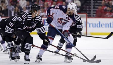 Columbus Blue Jackets center Boone Jenner (38) battles for the puck with New Jersey Devils center Dawson Mercer (91) during the first period of an NHL hockey game Tuesday, March 11, 2025, in Newark, N.J. (AP Photo/Adam Hunger)