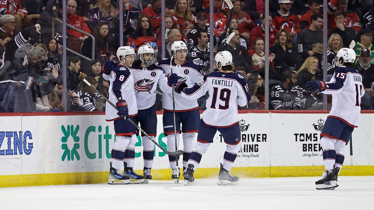 Columbus Blue Jackets right wing Kirill Marchenko, second left, is congratulated by teammates after scoring a goal during the second period of an NHL hockey game against the New Jersey Devils, Tuesday, March 11, 2025, in Newark, N.J. (AP Photo/Adam Hunger)