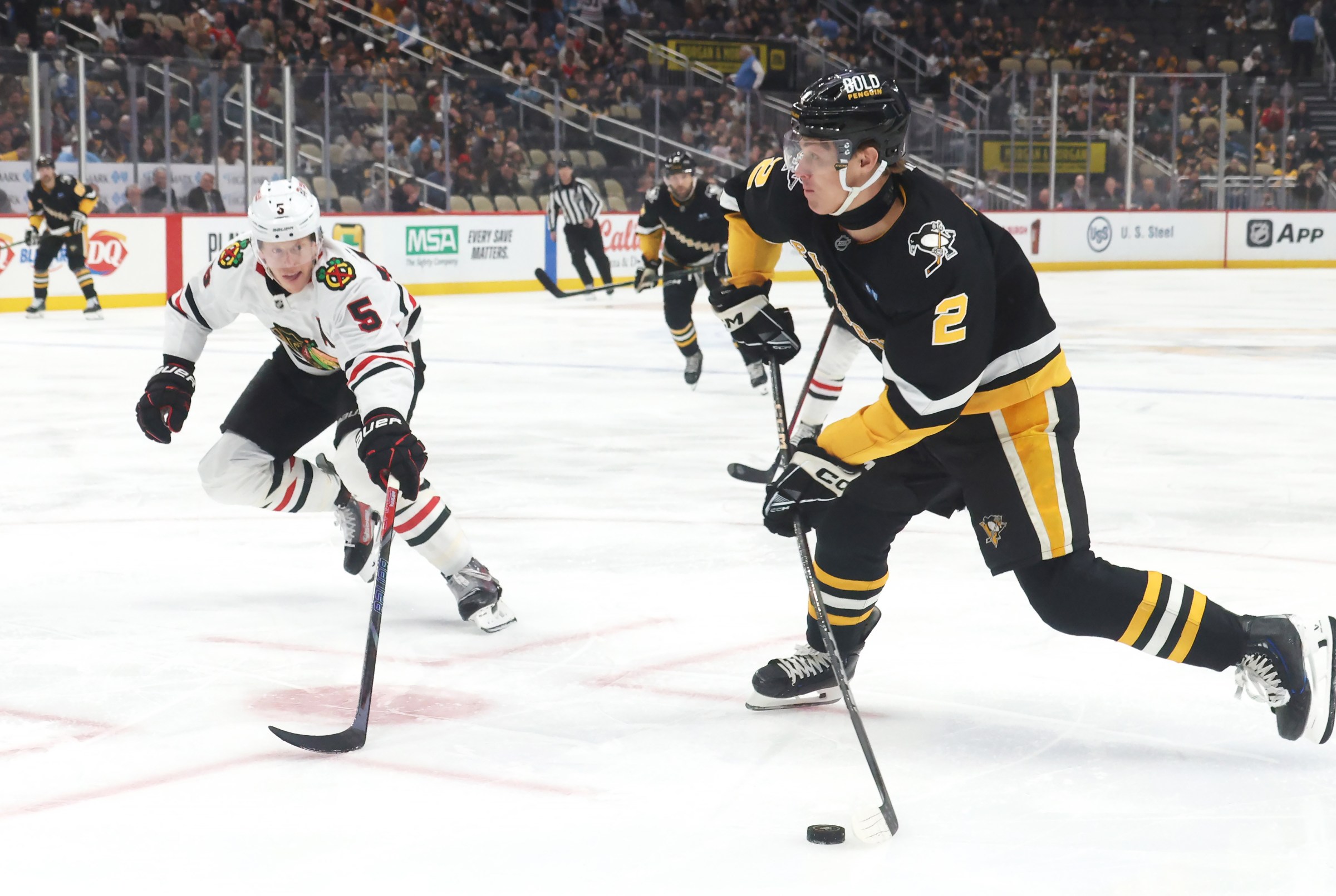 Apr 8, 2025; Pittsburgh, Pennsylvania, USA; Pittsburgh Penguins right wing Rutger McGroarty (2) shoots the puck as Chicago Blackhawks defenseman Connor Murphy (5) defends during the first period at PPG Paints Arena. Mandatory Credit: Charles LeClaire-Imagn Images