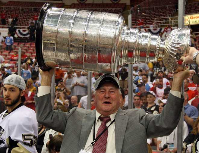 DETROIT - JUNE 12:  Senior advisor of hockey operations Eddie Johnston of the Pittsburgh Penguins celebrates with the Stanley Cup after defeating the Detroit Red Wings by a score of 2-1 to win Game Seven and the 2009 NHL Stanley Cup Finals at Joe Louis Arena on June 12, 2009 in Detroit, Michigan.  (Photo by Jim McIsaac/Getty Images)