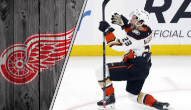 Detroit Red Wings logo to the left, with a photo of Mason McTavish to the right, illustrating the latest NHL trade rumors.