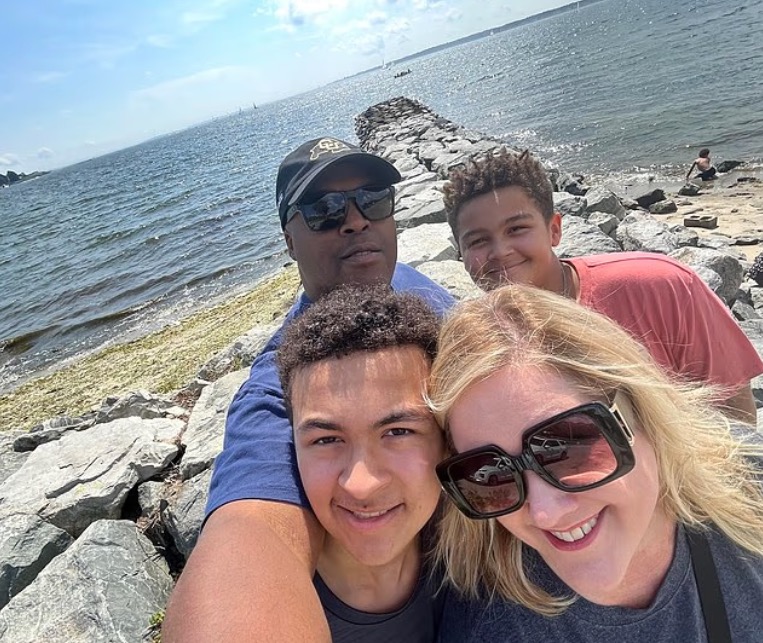 Family selfie by the water.