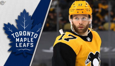 Pittsburgh Penguins forward Bryan Rust look on during an NHL game, with a focus on the ongoing NHL trade rumors surrounding him.