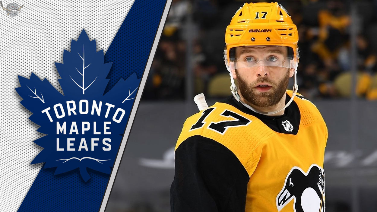 Pittsburgh Penguins forward Bryan Rust look on during an NHL game, with a focus on the ongoing NHL trade rumors surrounding him.