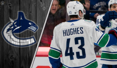 Vancouver Canucks captain Quinn Hughes looks on during a game, representing the focus of current NHL trade rumors