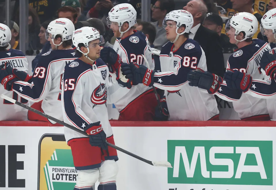 Sep 27, 2025; Pittsburgh, Pennsylvania, USA; Columbus Blue Jackets center Luca Del Bel Belluz (65) celebrates his goal with the Blue Jackets bench against the Pittsburgh Penguins during the first period at PPG Paints Arena. Mandatory Credit: Charles LeClaire-Imagn Images