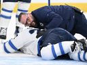 Winnipeg Jets forward Nikolaj Ehlers is attended to by team head athletic therapist Rob Millette after Ehlers was hit with a puck during a game against the Vegas Golden Knights at T-Mobile Arena on April 3, 2025 in Las Vegas, Nevada.
