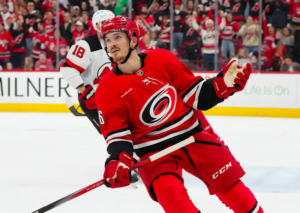 Dec 28, 2024; Raleigh, North Carolina, USA; Carolina Hurricanes center Jack Roslovic (96) celebrates his empty net goal against the New Jersey Devils during the third period at Lenovo Center. Mandatory Credit: James Guillory-Imagn Images