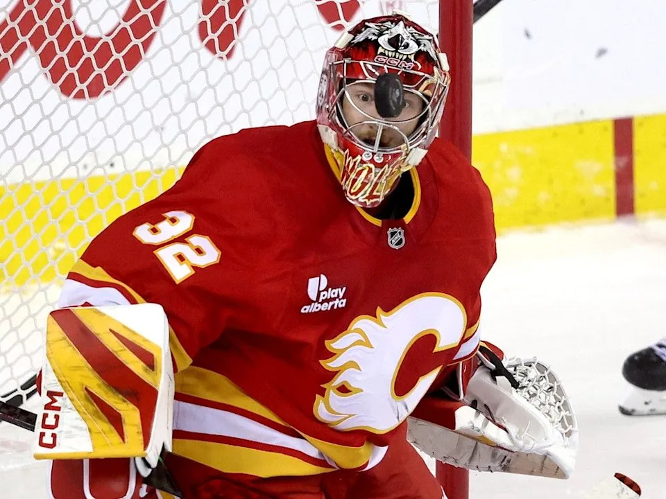 Flames goalie Dustin Wolf stops a Kraken shot on Tuesday.