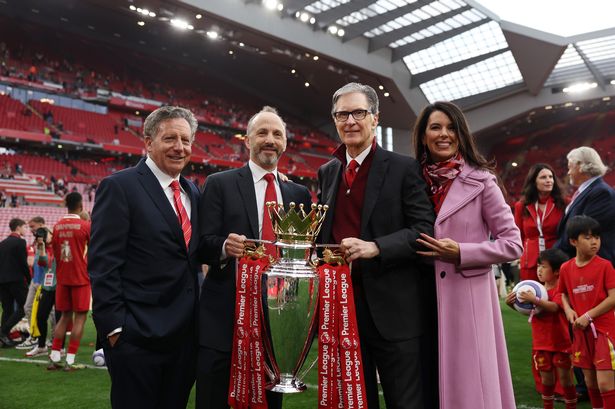 Tom Werner, Chairman of Liverpool, Michael Gordon, President of Fenway Sports Group and John Henry, Principle Owner of Liverpool and his wife Linda Pizzuti Henry pose for a photograph with the Premier League trophy